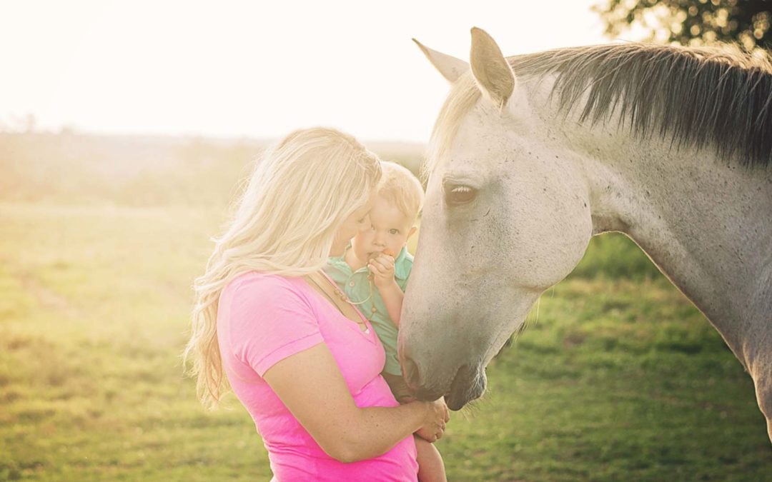 Mollie Vacco, with son and one of her horses.